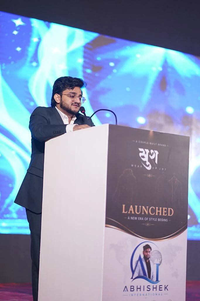 Mujahid Azimabadi speaking at a podium